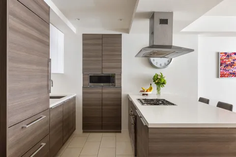 a kitchen with a refrigerator and a stove