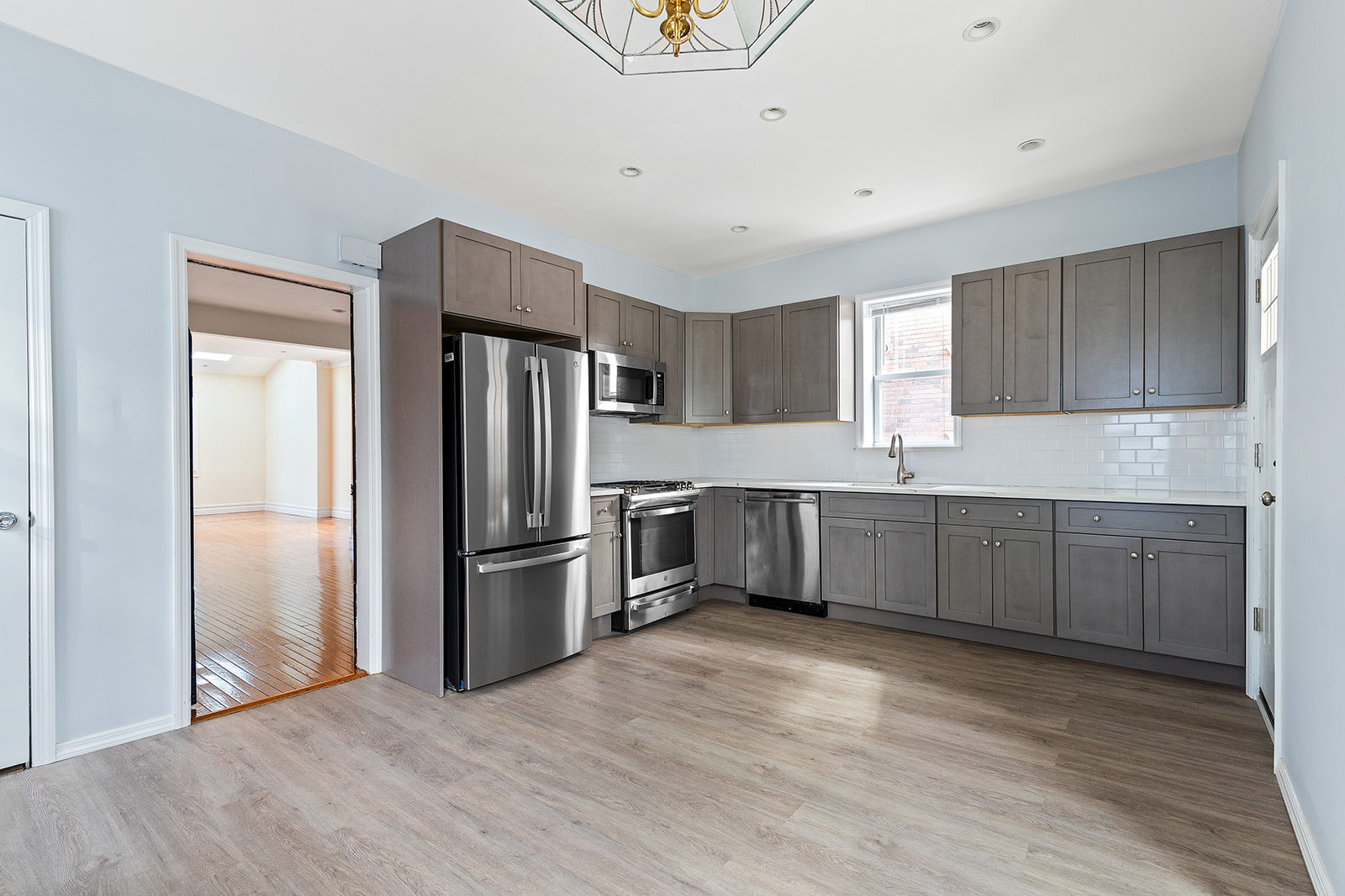 96 86th Street Brooklyn, NY 11209 - Photo 4 of 13 a kitchen with a refrigerator and a sink