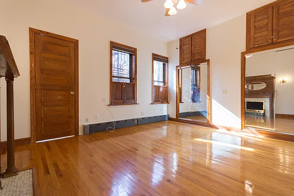 688 Saint Marks Avenue, Unit 1 Brooklyn, NY 11216 - Photo 7 of 10 an empty room with wooden floor and windows