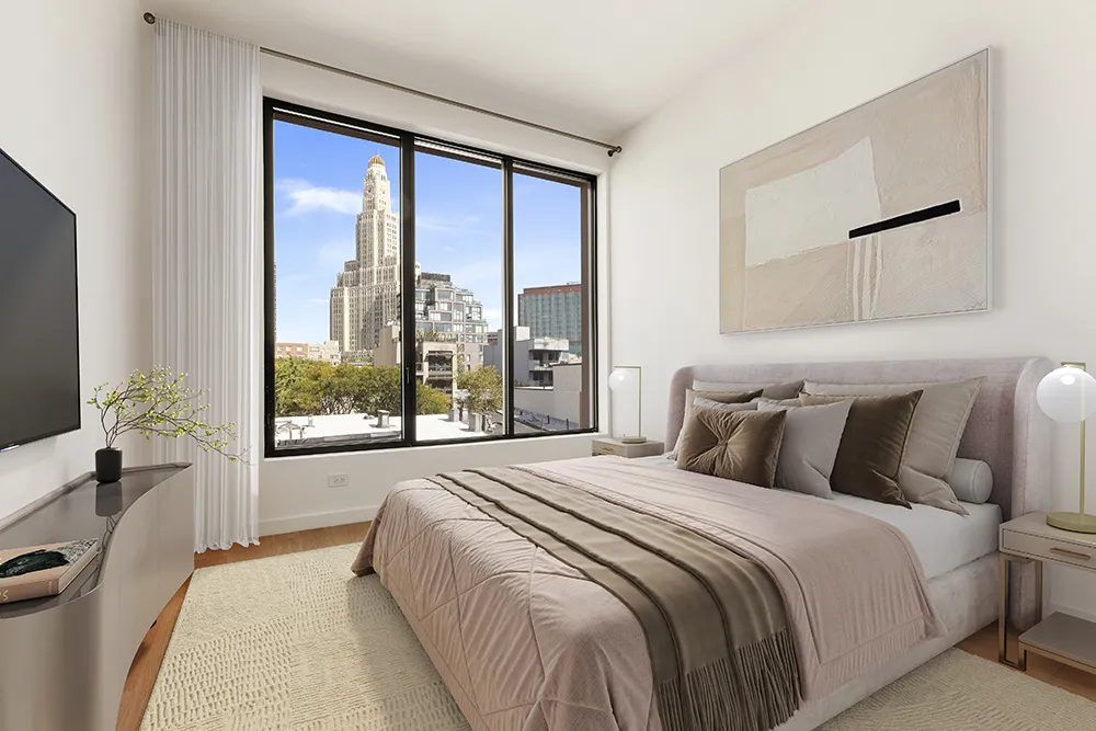 a bedroom with a large bed and a large window
