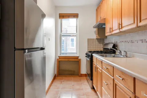 a kitchen with granite countertop a refrigerator and a sink