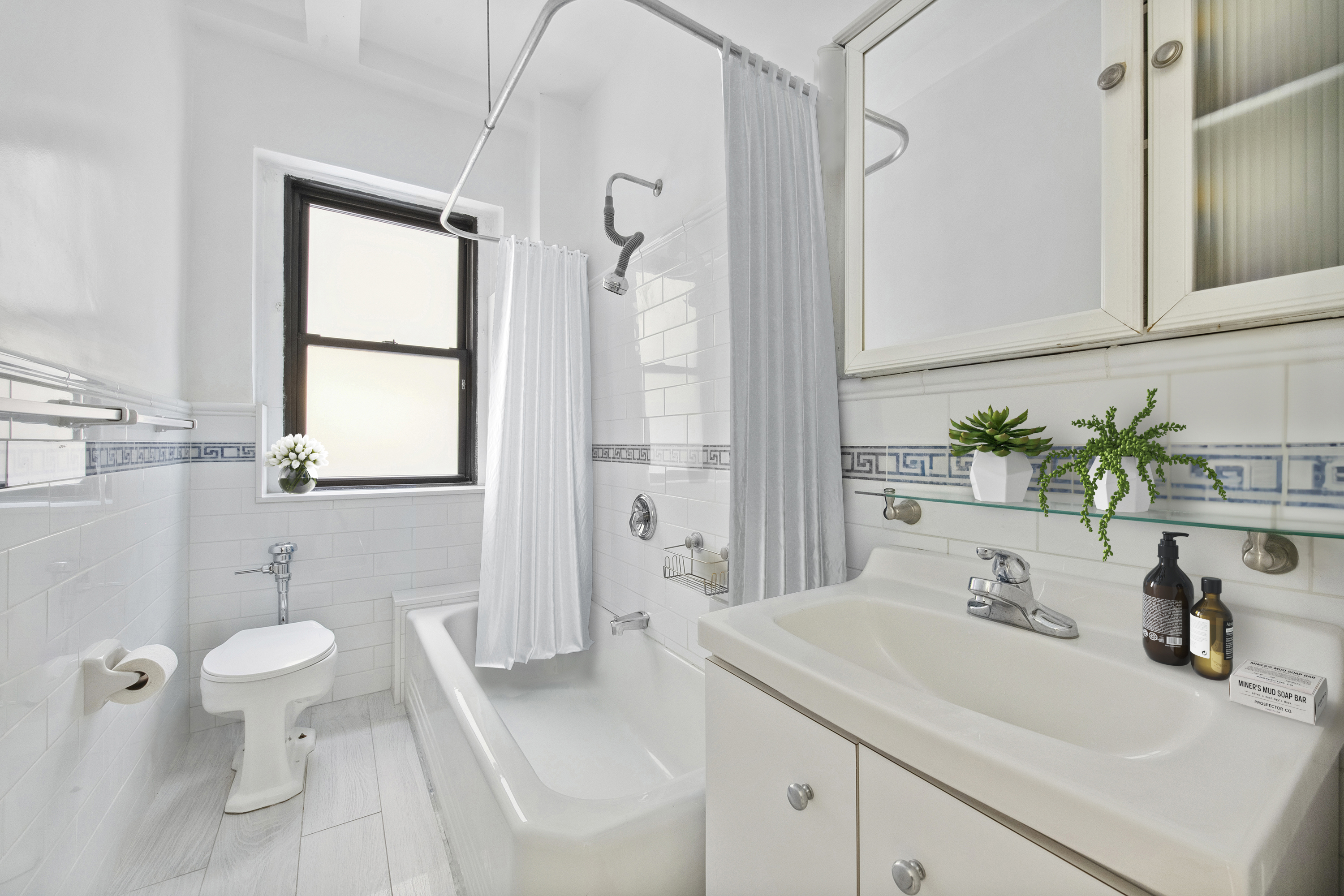 609 West 114th Street, Unit 2 Manhattan, NY 10025 - Photo 9 of 16 a bathroom with a sink a toilet and shower