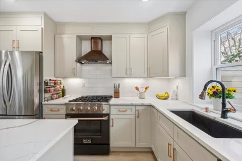 a kitchen with a stove a refrigerator and a sink