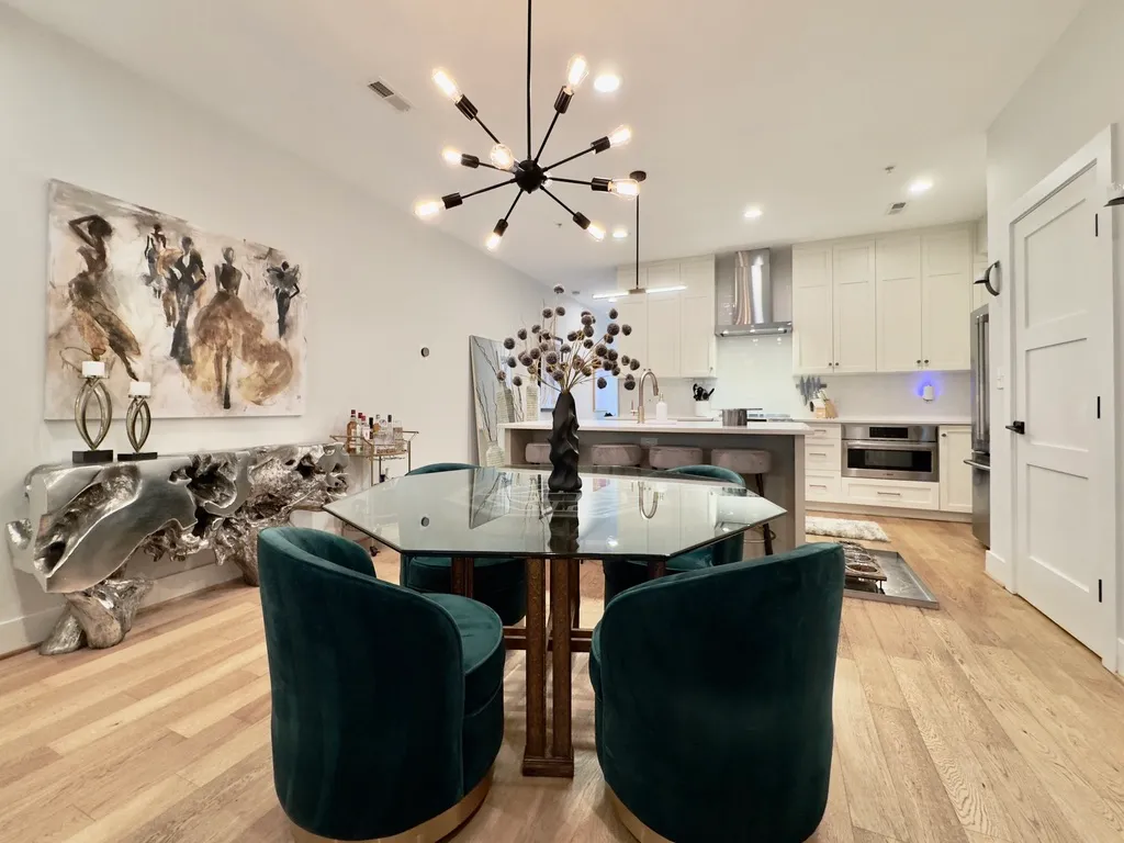 a living room with kitchen island furniture and a chandelier