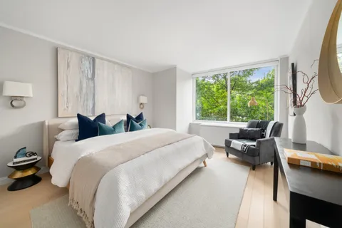 a bed room with a bed and a chair