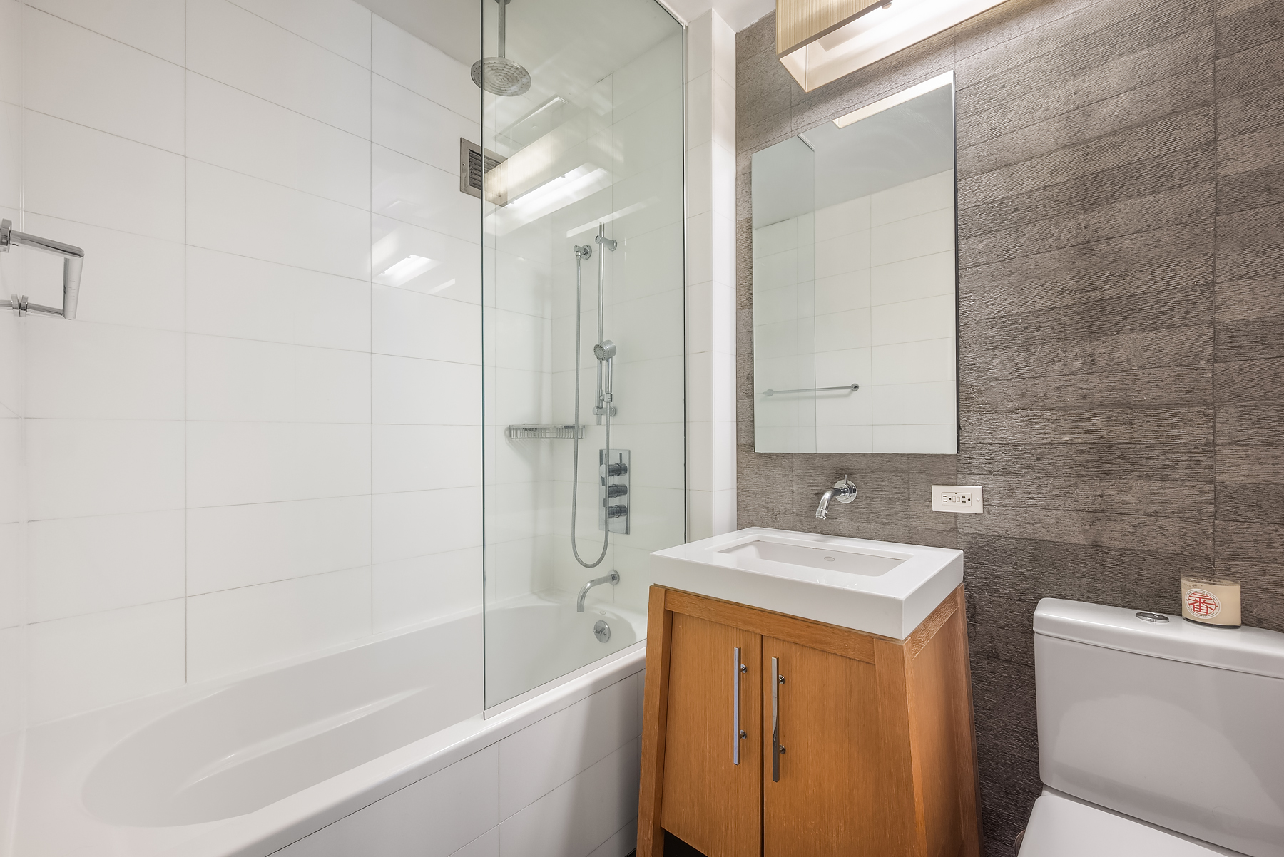 88 Greenwich Street, Unit 1605 Manhattan, NY 10006 - Photo 4 of 32 a bathroom with a sink a toilet and shower