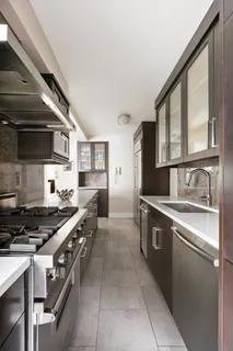 a kitchen with stainless steel appliances granite countertop a stove and a sink