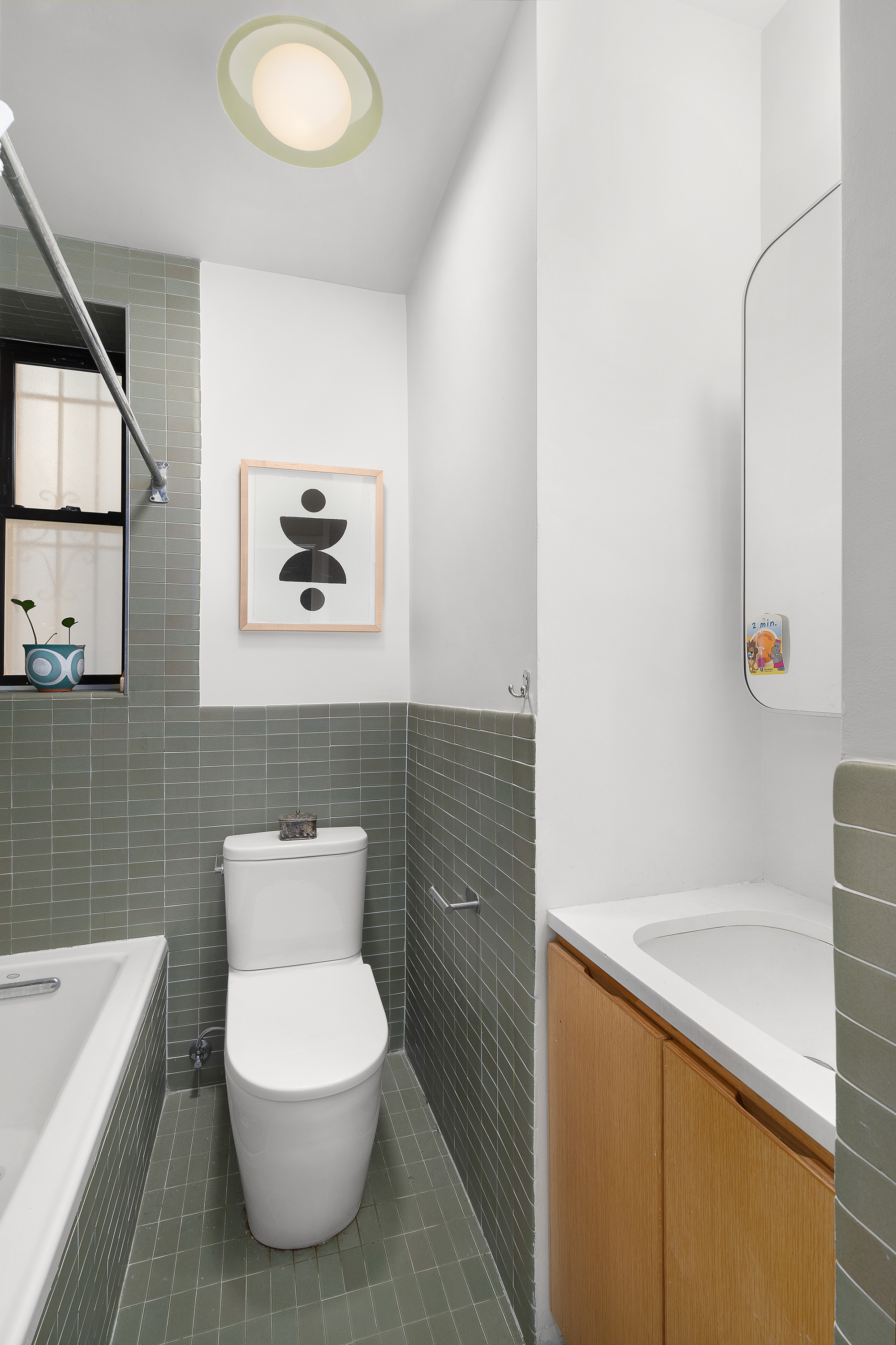 226 St James Place, Unit 1R Brooklyn, NY 11238 - Photo 11 of 14 a bathroom with a toilet sink and mirror