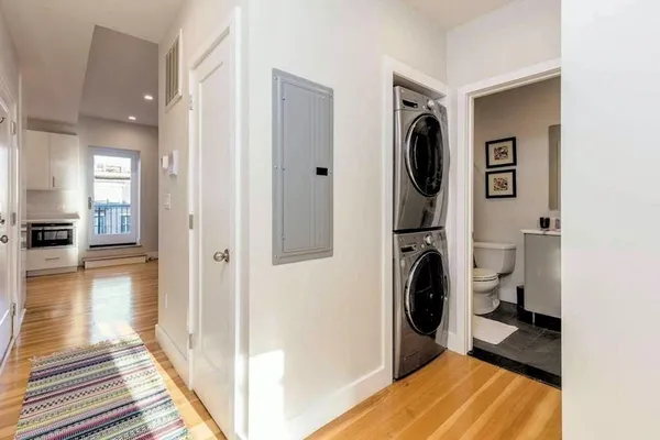 a view of a hallway with a washer and dryer