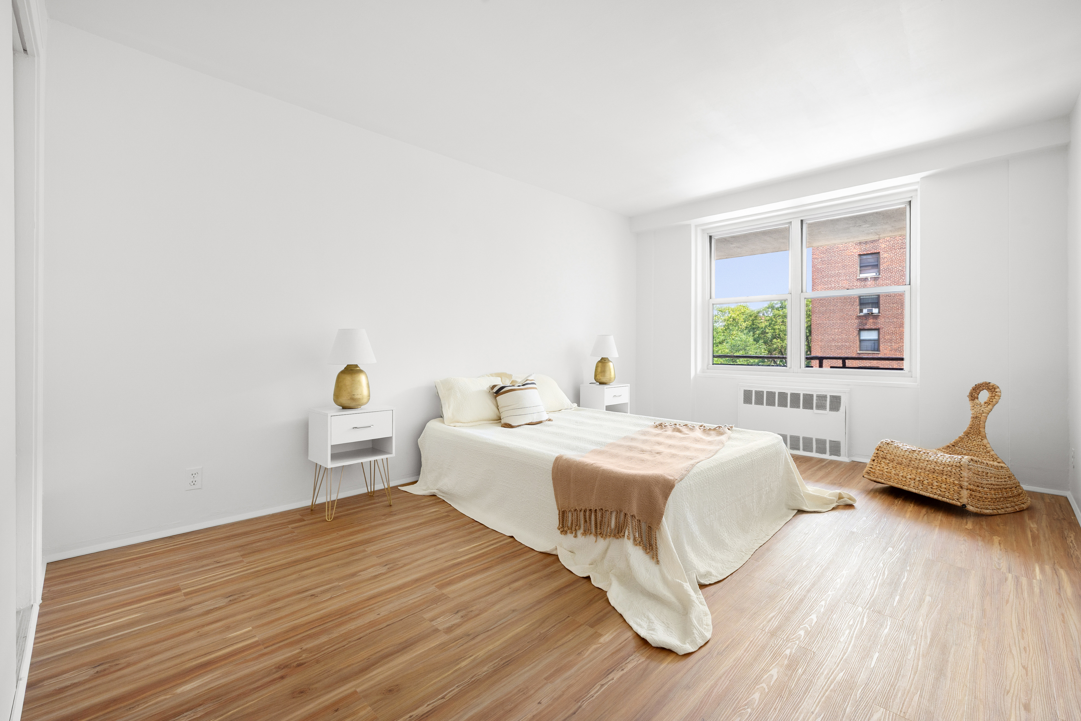 35-31 85th Street, Unit 6C Queens, NY 11372 - Photo 8 of 11 a bedroom with a bed and wooden floor