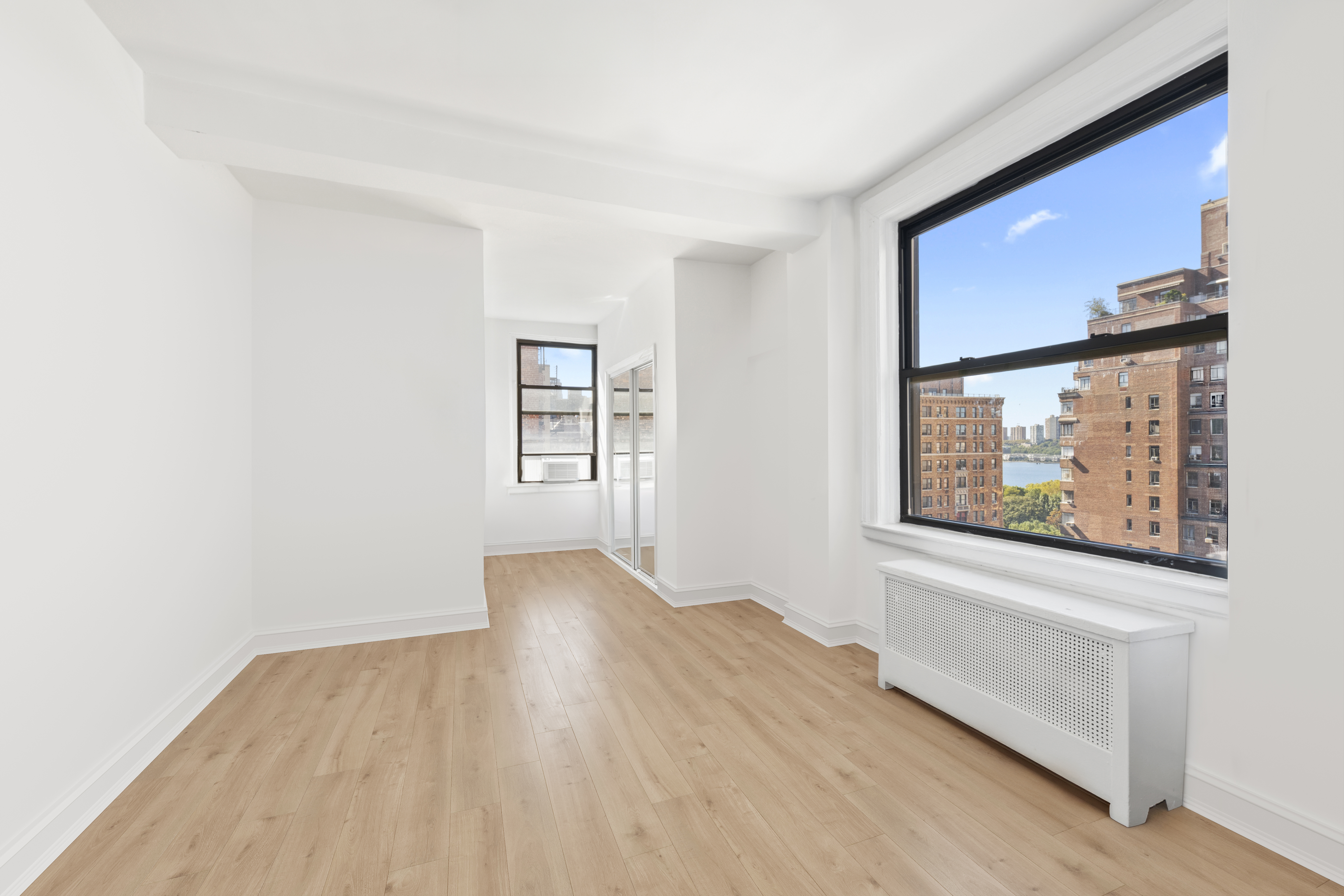 473 West End Avenue, Unit 13D Manhattan, NY 10024 - Photo 10 of 13 an empty room with wooden floor and a window