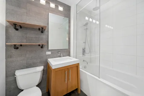 a bathroom with a toilet sink and shower