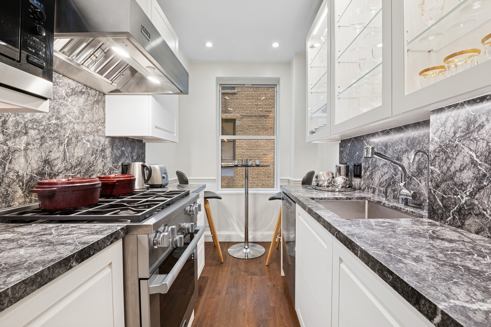 108 East 91st Street, Unit 4B Manhattan, NY 10128 - Photo 2 of 11 a kitchen with stainless steel appliances granite countertop a sink stove and cabinets