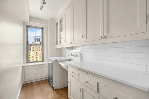 a kitchen with granite countertop white cabinets and white appliances
