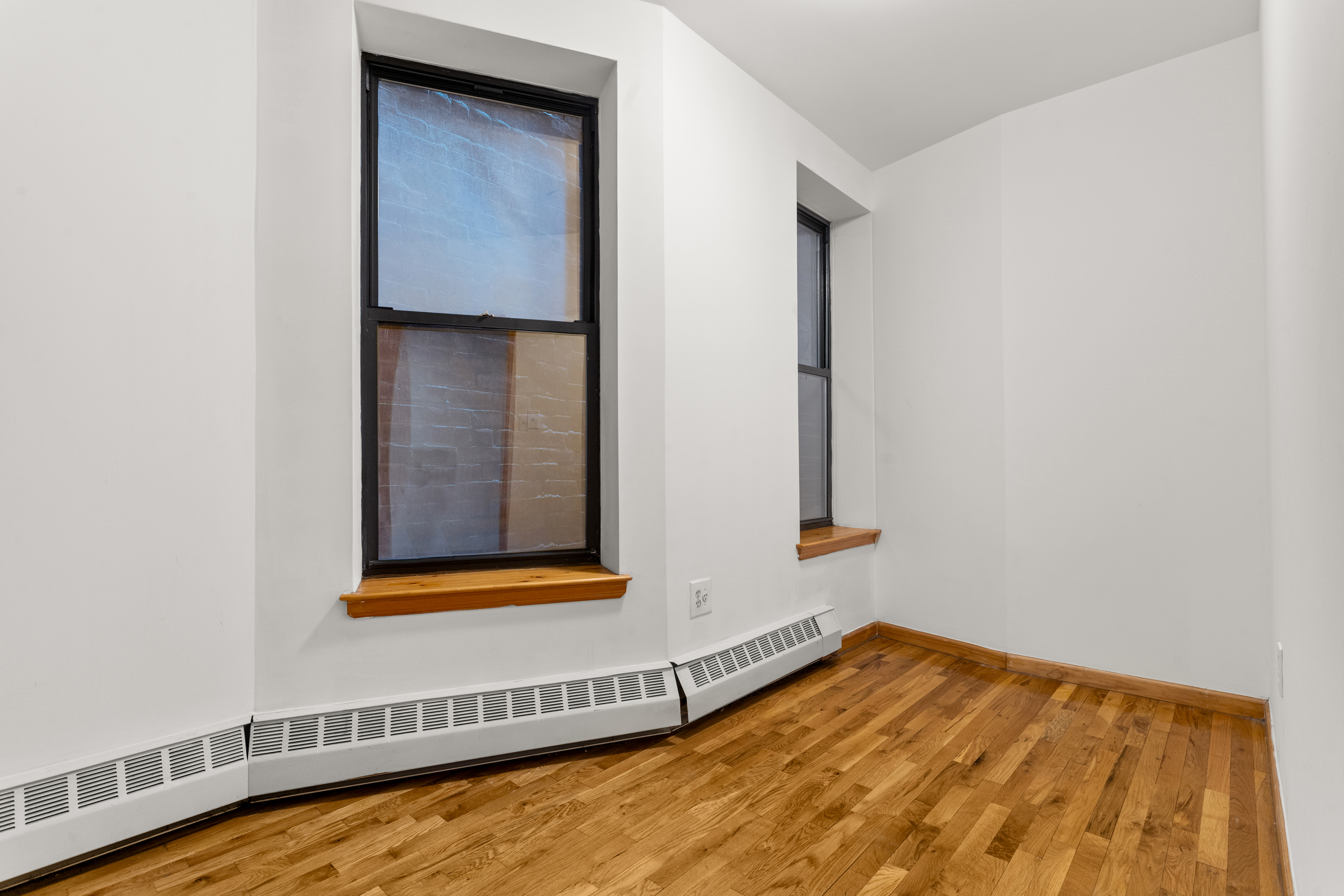 316 West 47th Street, Unit 1FE Manhattan, NY 10036 - Photo 7 of 9 a view of a small space with wooden floor and a window