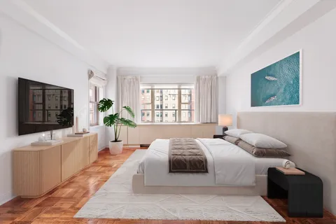 a bedroom with a large bed and a flat screen tv