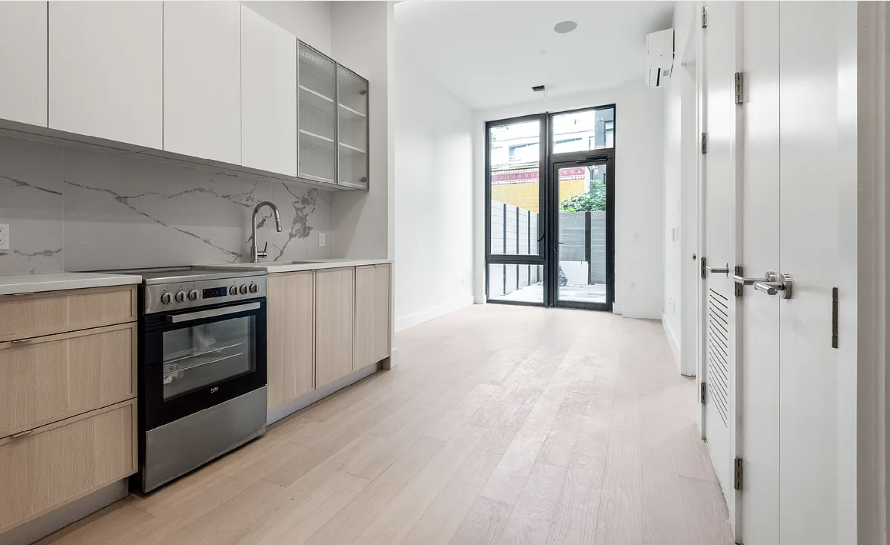 218 Front Street, Unit 184 Brooklyn, NY 11201 - Photo 12 of 13 a view of a kitchen with a stove cabinets and a wooden floor