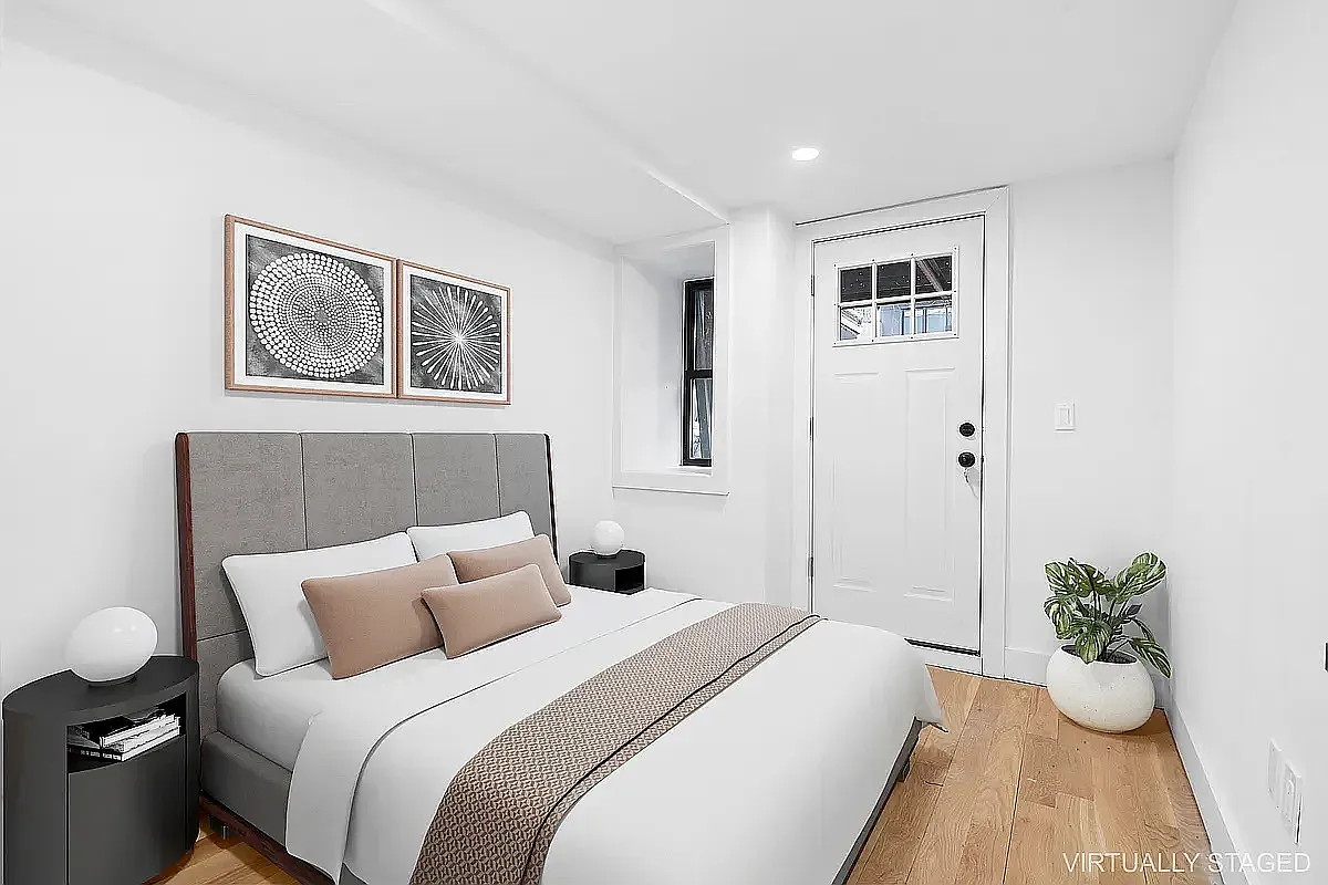 587 Van Buren Street, Unit 1 Brooklyn, NY 11221 - Photo 5 of 8 a bed room with a bed and a potted plant