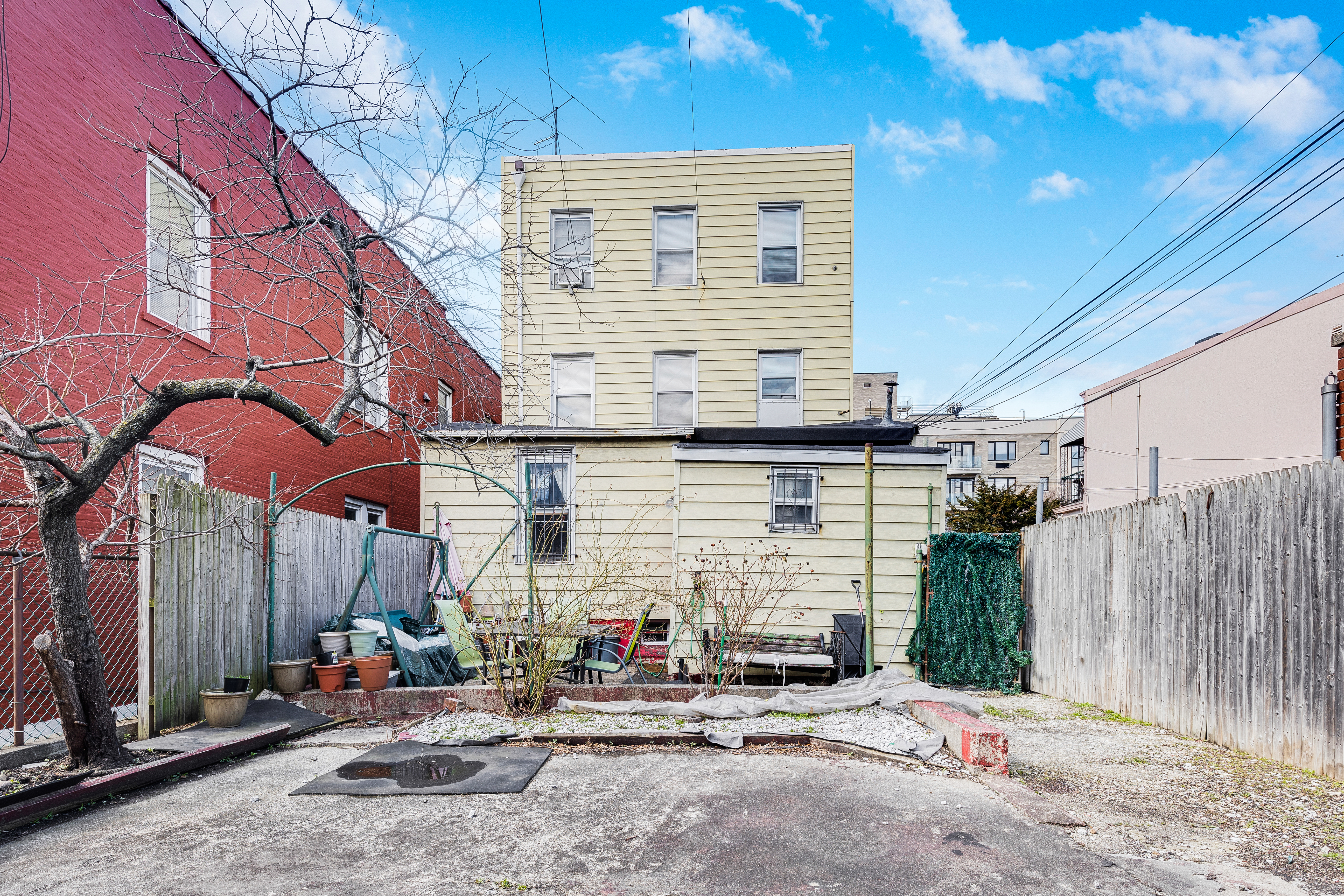 35-47 30th Street Queens, NY 11106 - Photo 12 of 14 a backyard of a house with outdoor seating