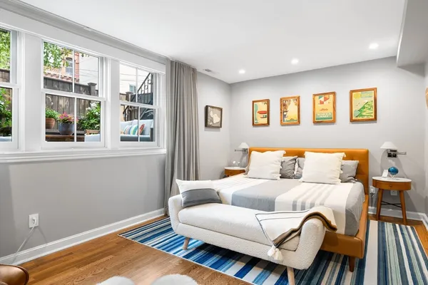 a living room with a bed and a window