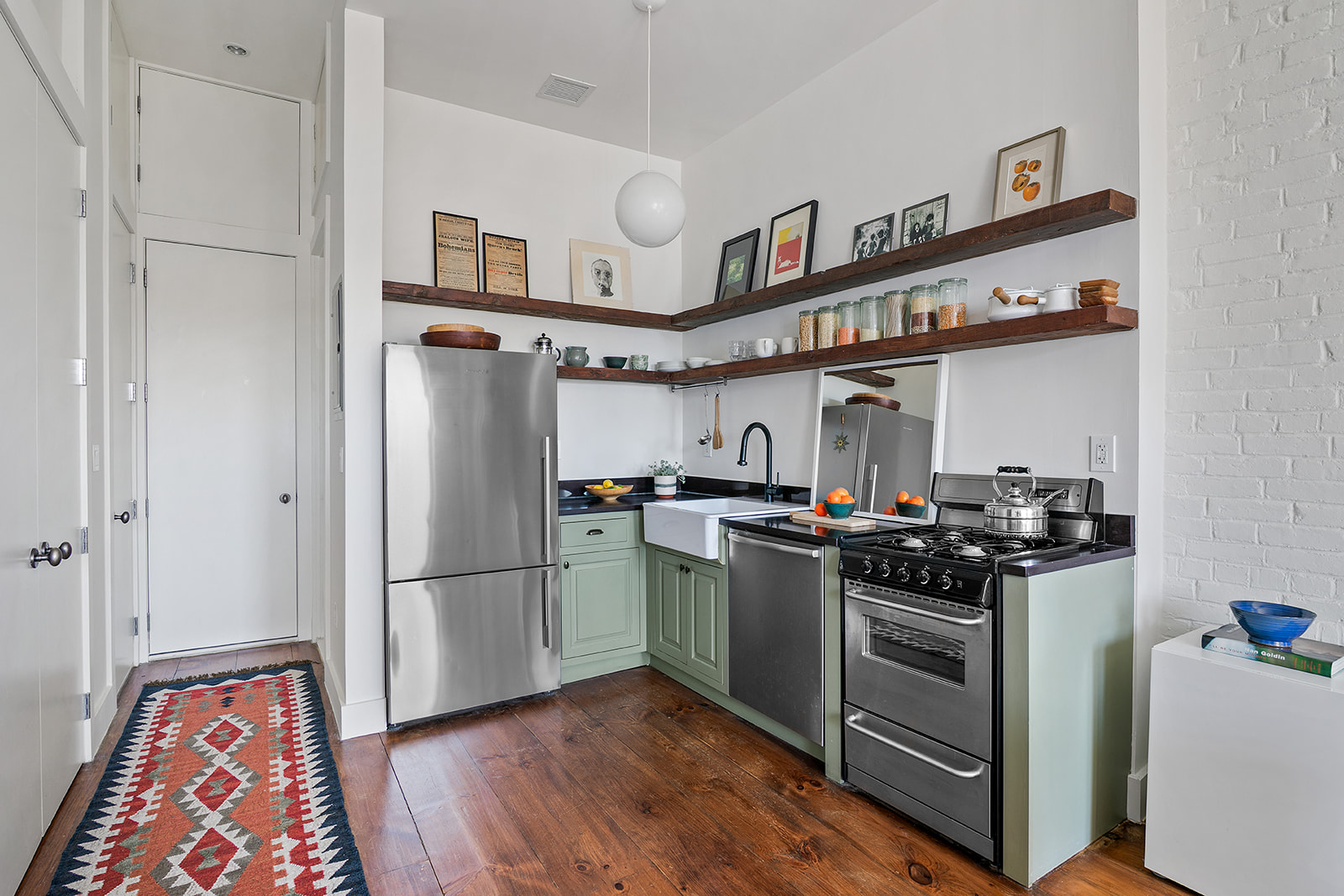 940 Fulton Street, Unit PHD Brooklyn, NY 11238 - Photo 4 of 9 a kitchen with stainless steel appliances granite countertop a stove and a refrigerator