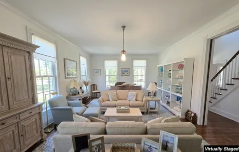 a kitchen with stainless steel appliances granite countertop a sink a stove and a wooden floors