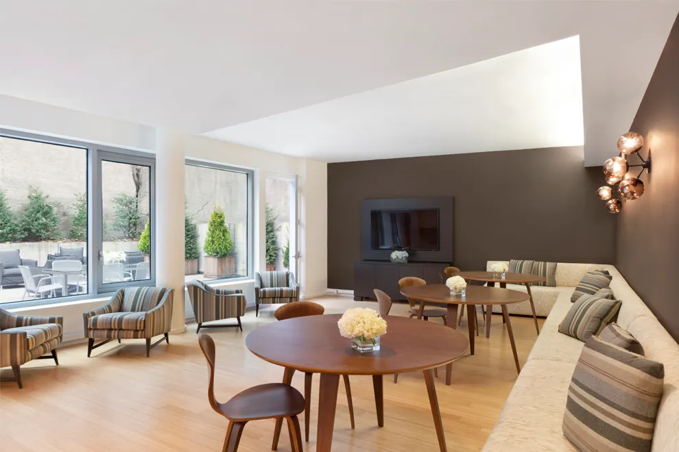 425 West 53rd Street, Unit 419 Manhattan, NY 10019 - Photo 12 of 18 a view of a dining room with furniture window and outside view