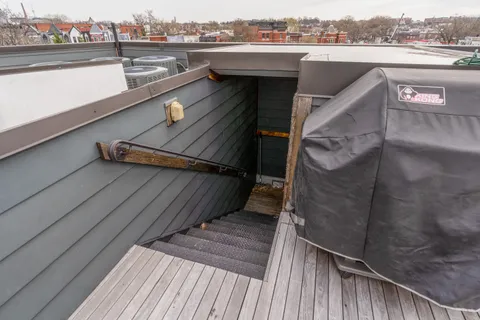 a view of a balcony with wooden floor and city view