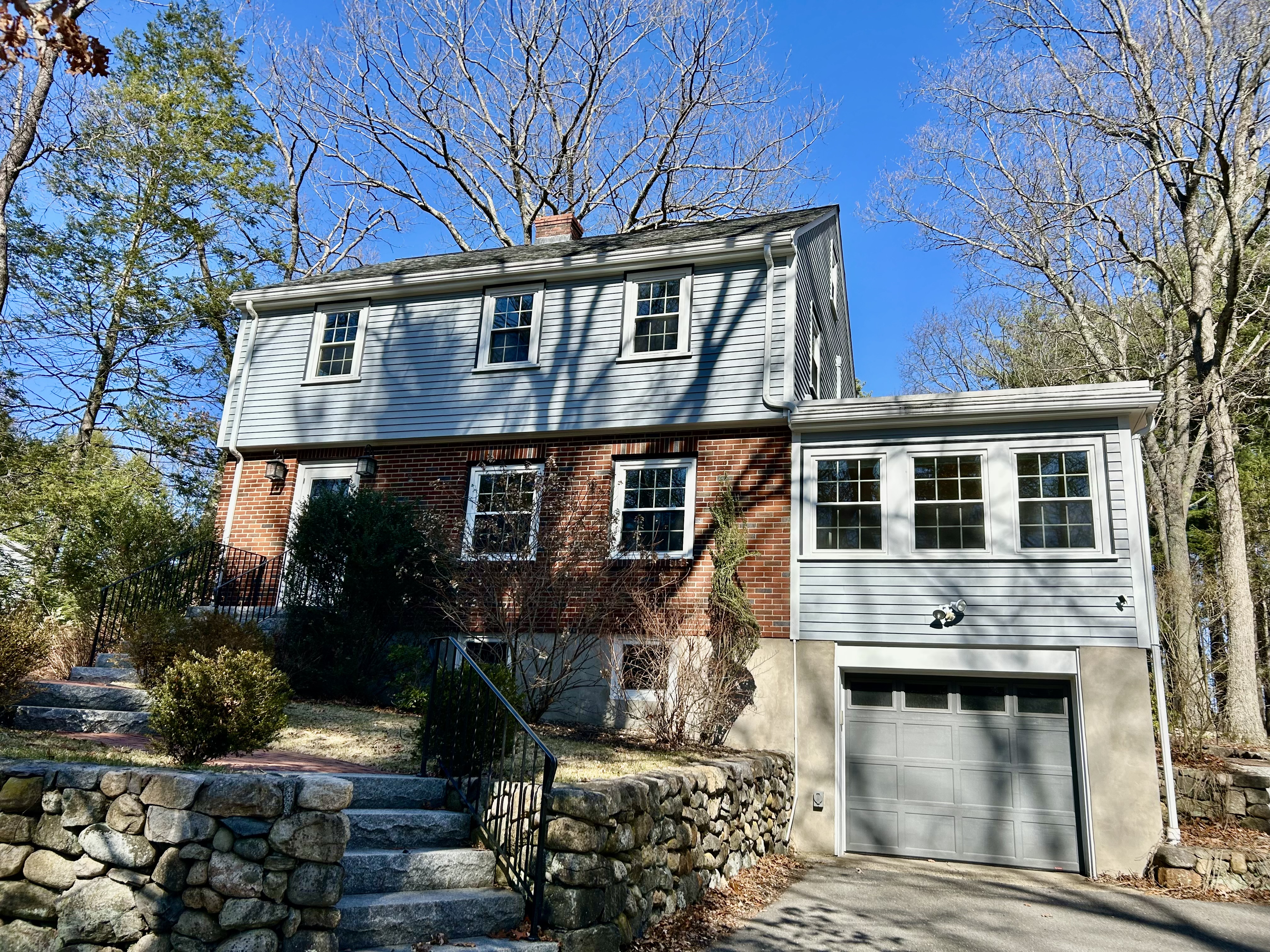 a front view of a house with a garden