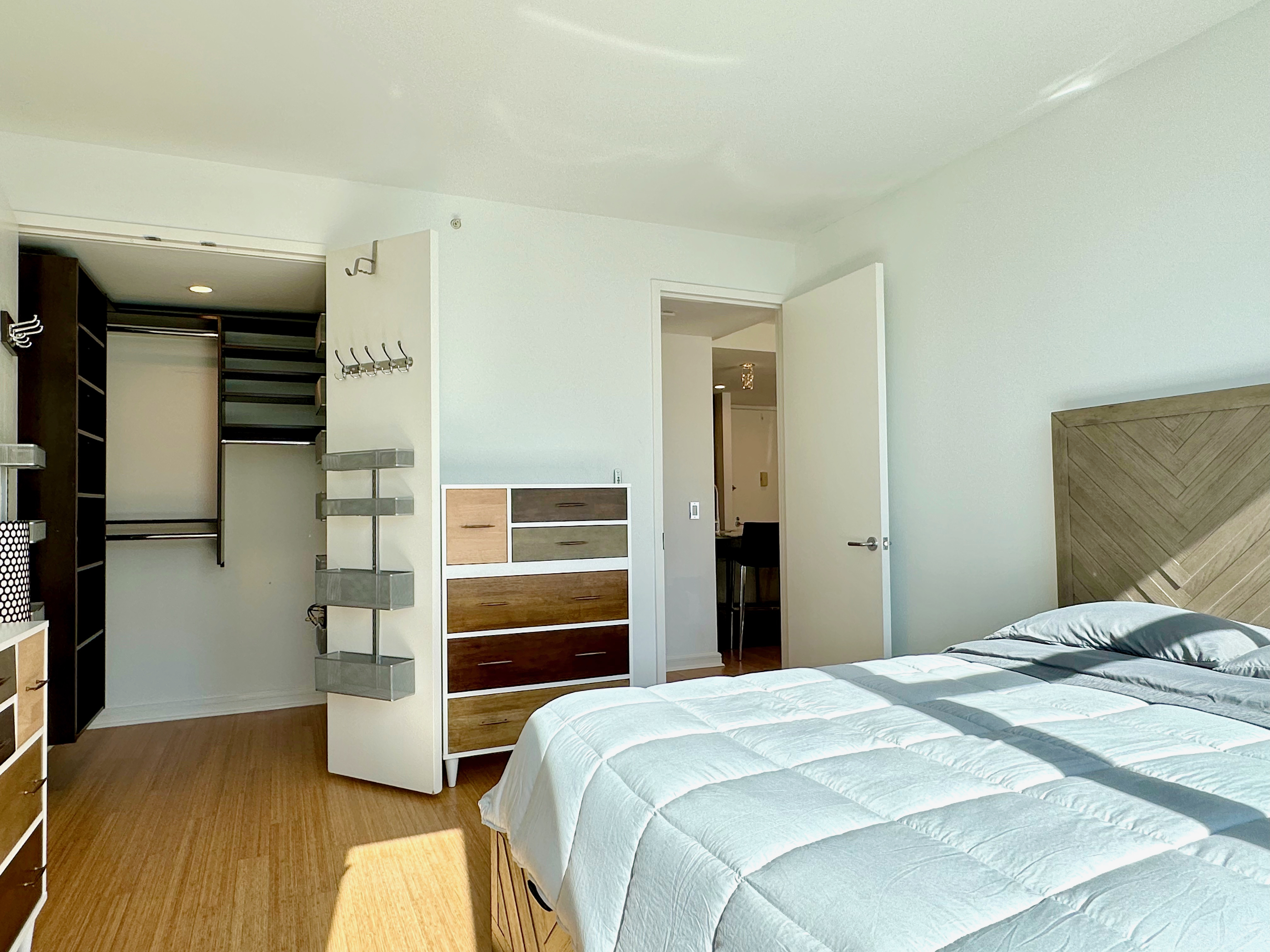 350 West 53rd Street, Unit PHA Manhattan, NY 10019 - Photo 18 of 35 a bedroom with a bed and wooden floor