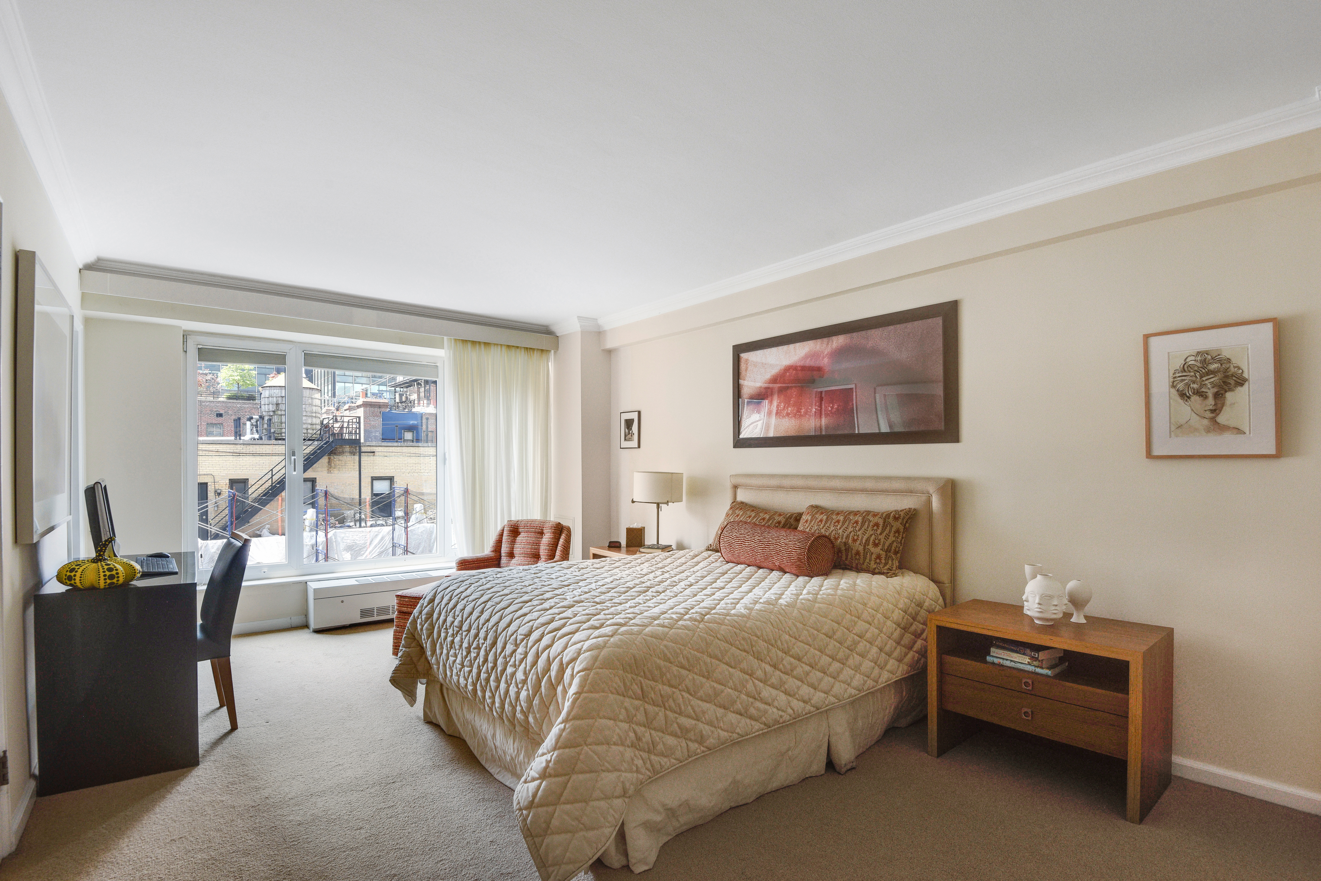 200 Central Park South, Unit 19J Manhattan, NY 10019 - Photo 4 of 12 a bedroom with a large bed and a large window