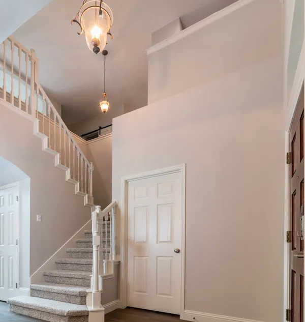 a view of entryway and hall with wooden floor