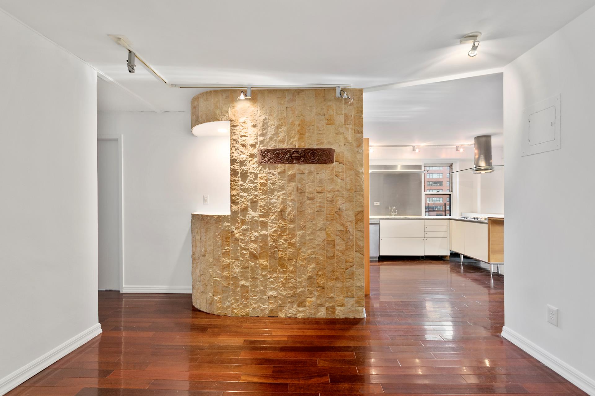 220 East 60th Street, Unit 7CD Manhattan, NY 10022 - Photo 5 of 11 a view of empty room with wooden floor and cabinet