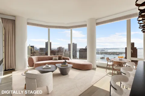 a living room with furniture and a floor to ceiling window