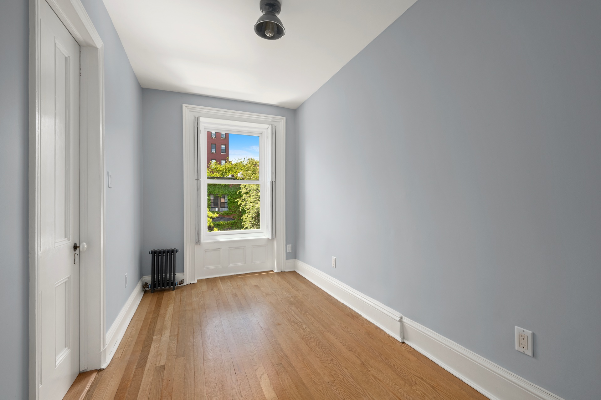 73 St James Place, Unit 2 Brooklyn, NY 11238 - Photo 12 of 15 an empty room with wooden floor and windows