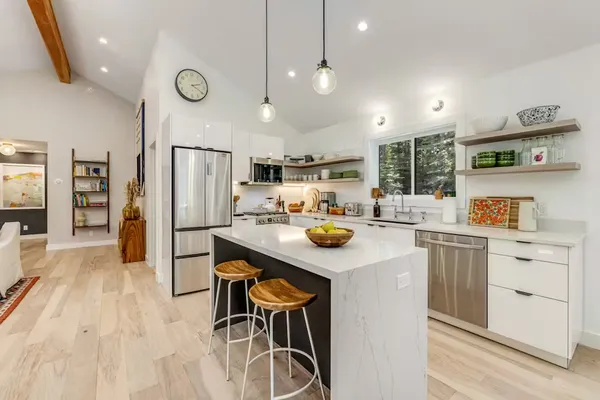 a kitchen with a sink a refrigerator and cabinets