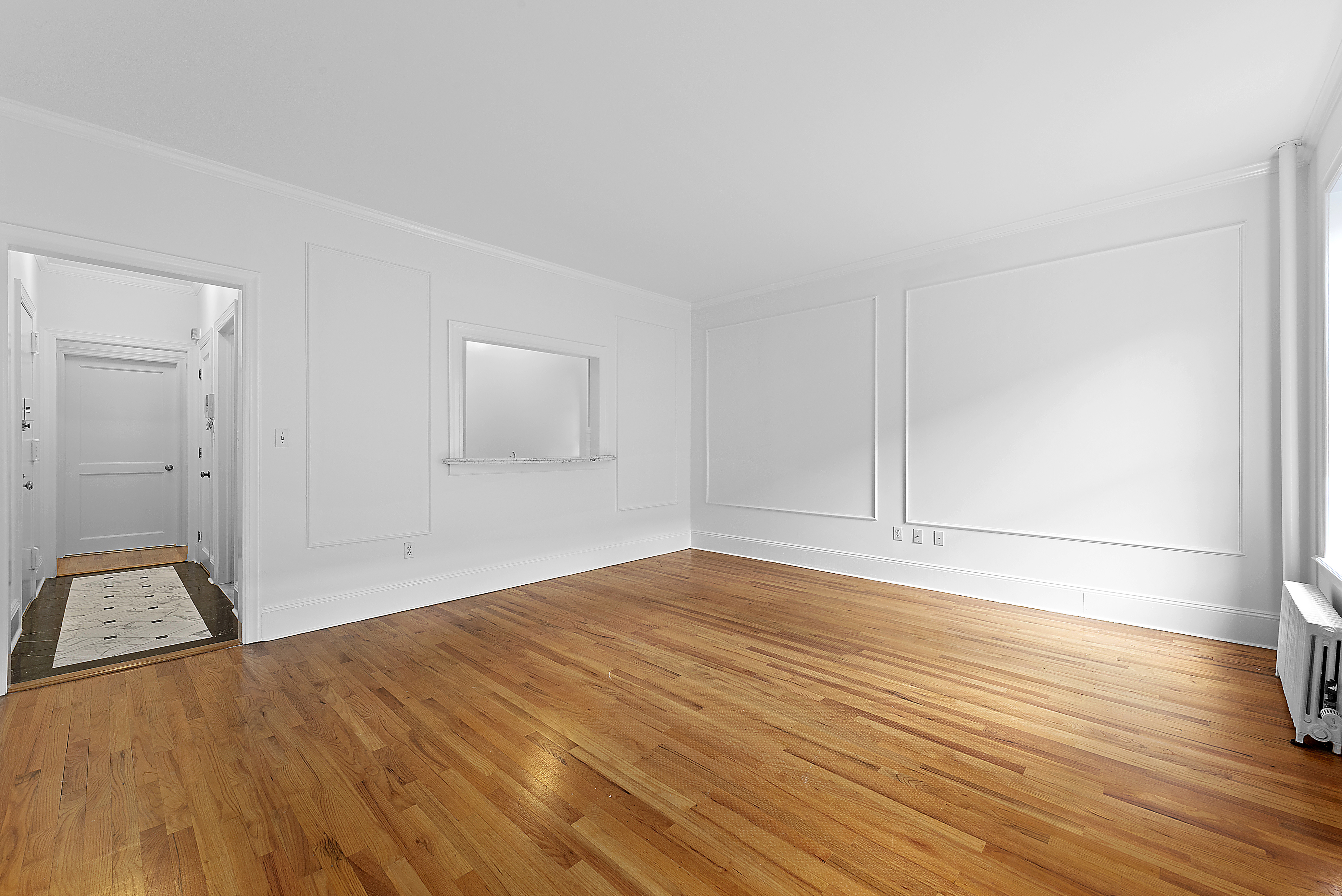 1240 Park Avenue, Unit 4C Manhattan, NY 10128 - Photo 2 of 9 a view of empty room with wooden floor