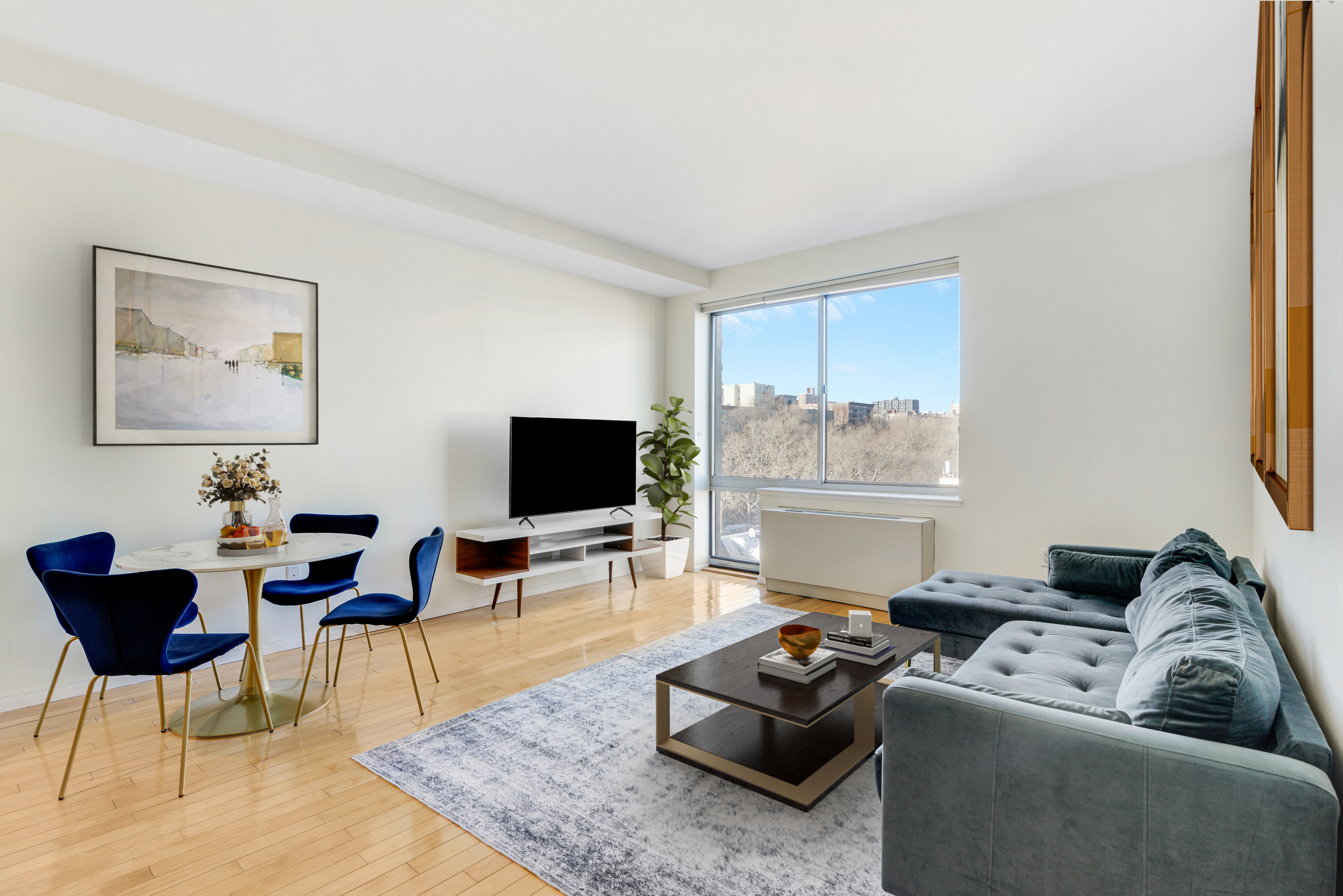 68 Bradhurst Avenue, Unit 8T Manhattan, NY 10039 - Photo 1 of 12 a living room with furniture and a flat screen tv