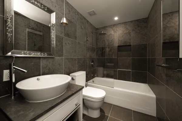 a bathroom with a toilet a sink and bathtub