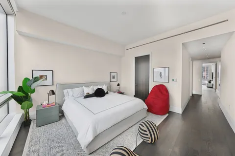 a room with a bed and wooden floor