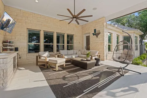 a living room with patio furniture and a large window