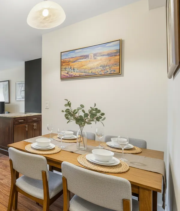 a dining room with furniture and wooden floor