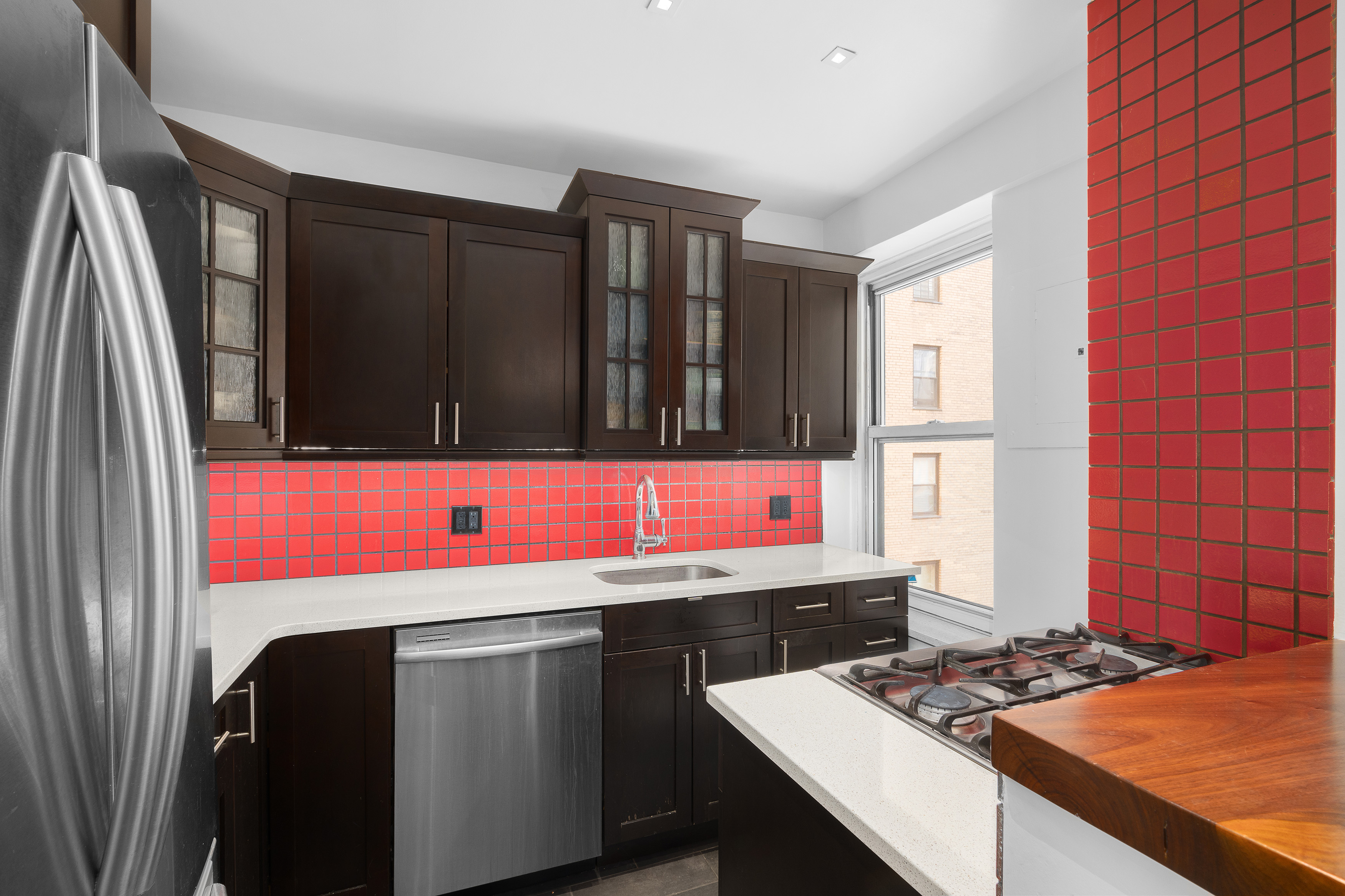 400 East 52nd Street, Unit 7A Manhattan, NY 10022 - Photo 2 of 9 a kitchen with a sink cabinets and window