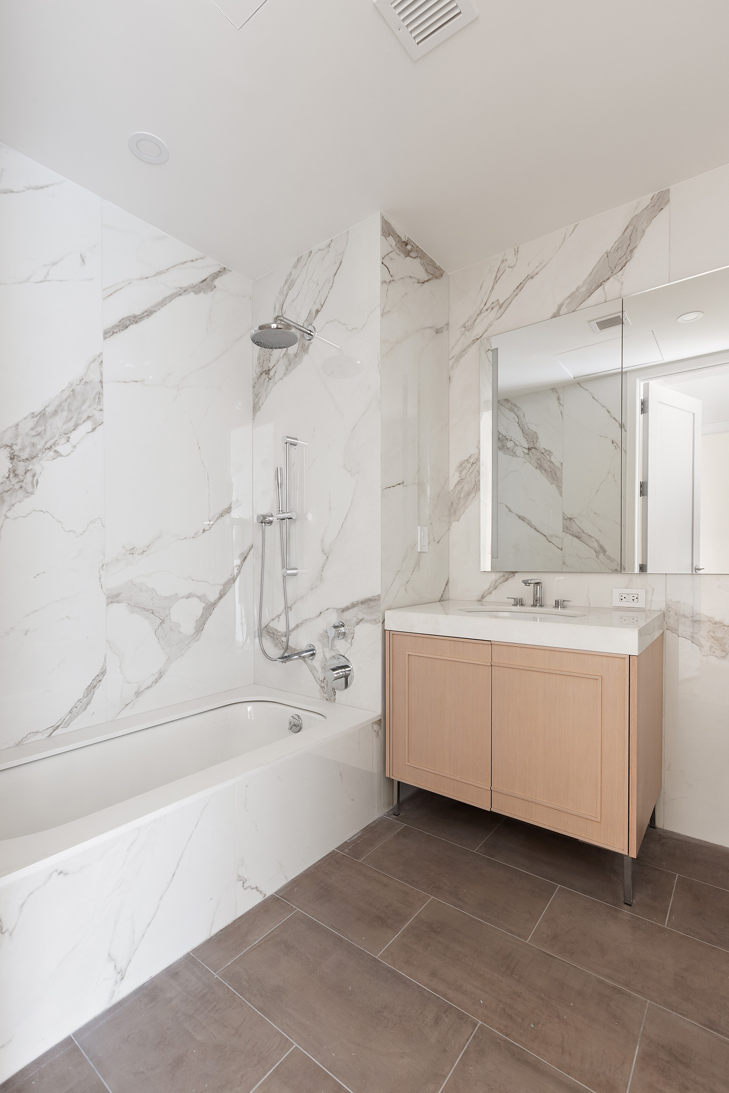 15 West 96th Street, Unit 19 Manhattan, NY 10025 - Photo 8 of 17 a bathroom with a double vanity sink a mirror and a bathtub