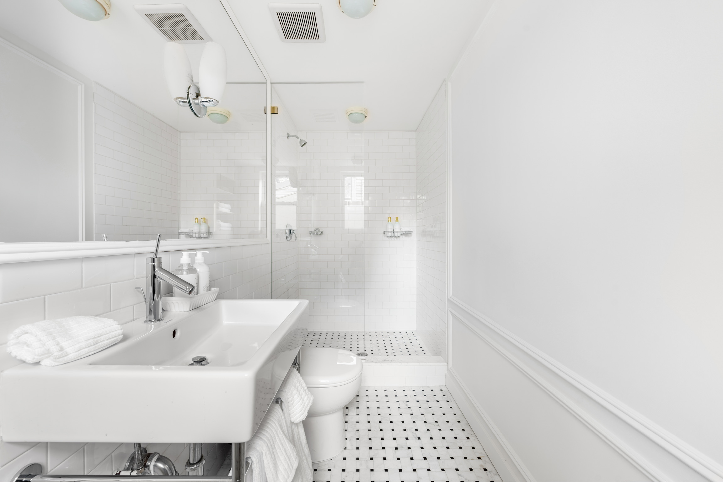 1200 Broadway, Unit PH89 Manhattan, NY 10001 - Photo 44 of 47 a bathroom with a sink a toilet and shower