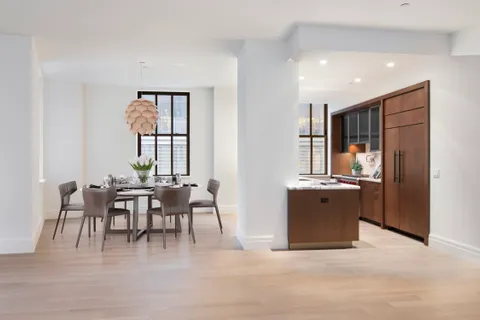 a kitchen with stainless steel appliances kitchen island granite countertop a refrigerator and a sink