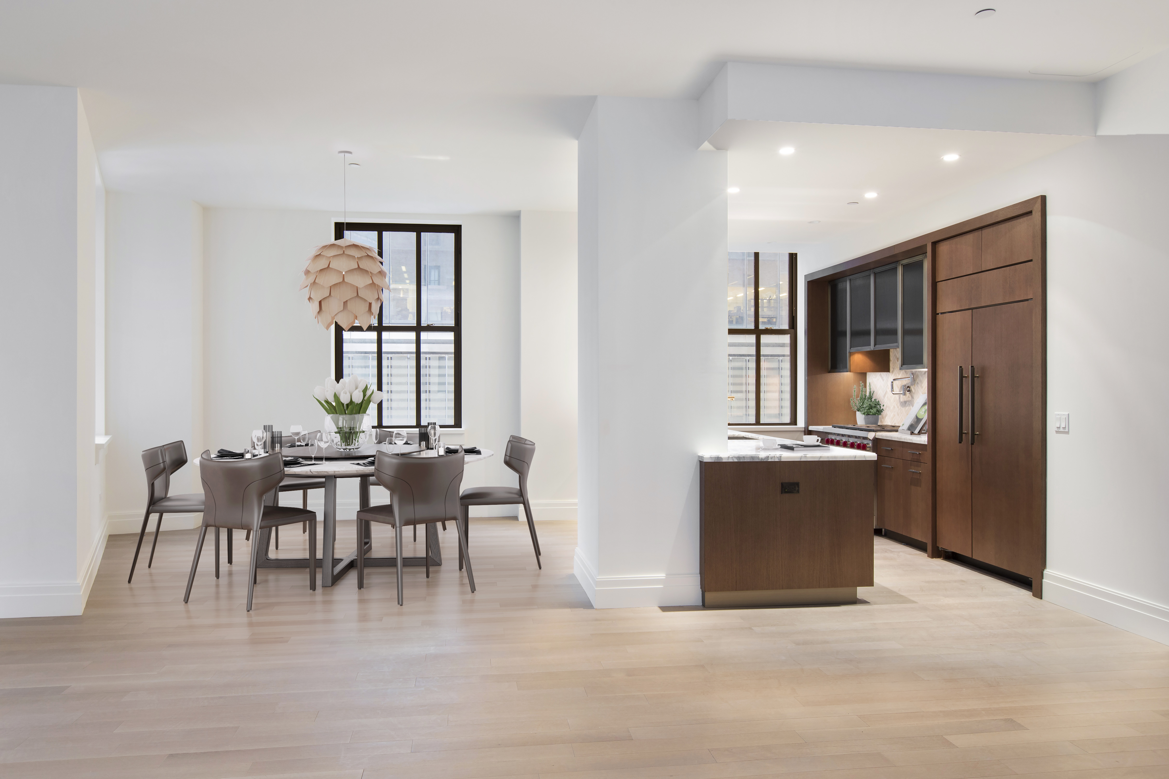 100 Barclay Street, Unit 12L Manhattan, NY 10007 - Photo 2 of 7 a dining room with furniture and a kitchen