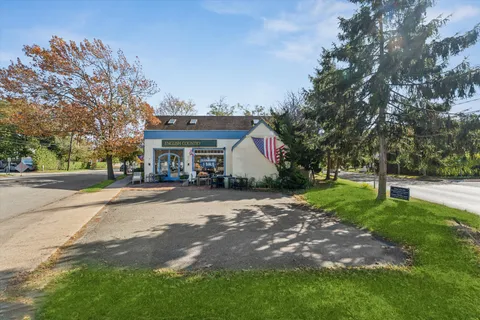 a front view of a house with a yard and trees