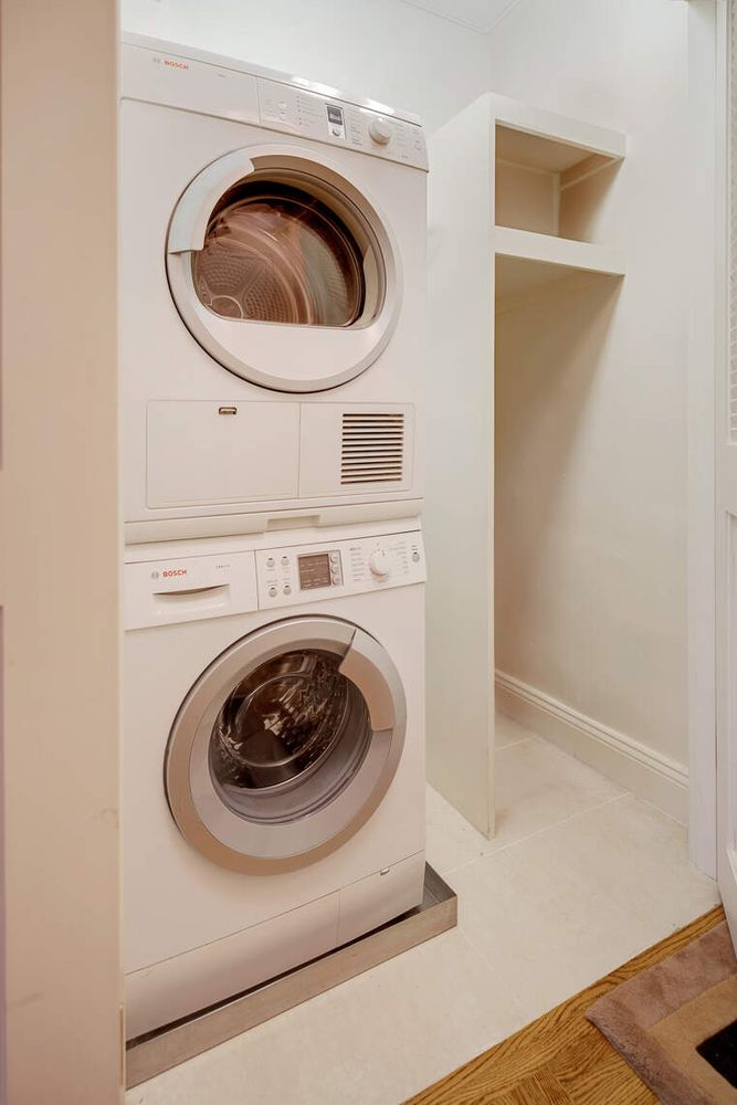 300 East 74th Street, Unit 18E Manhattan, NY 10021 - Photo 8 of 10 a utility room with dryer and washer