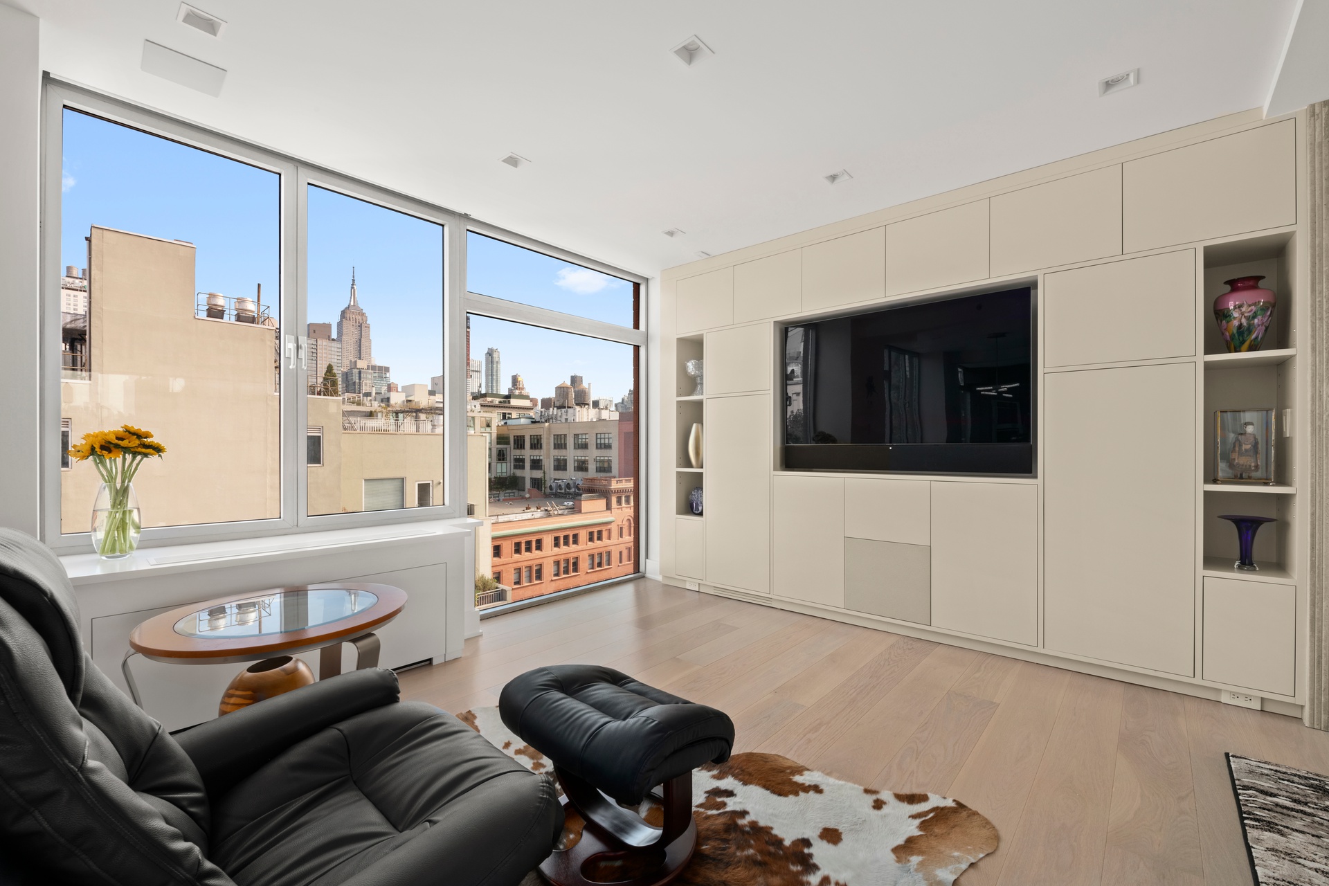 151 West 17th Street, Unit PHF Manhattan, NY 10011 - Photo 4 of 19 a living room with furniture and a flat screen tv